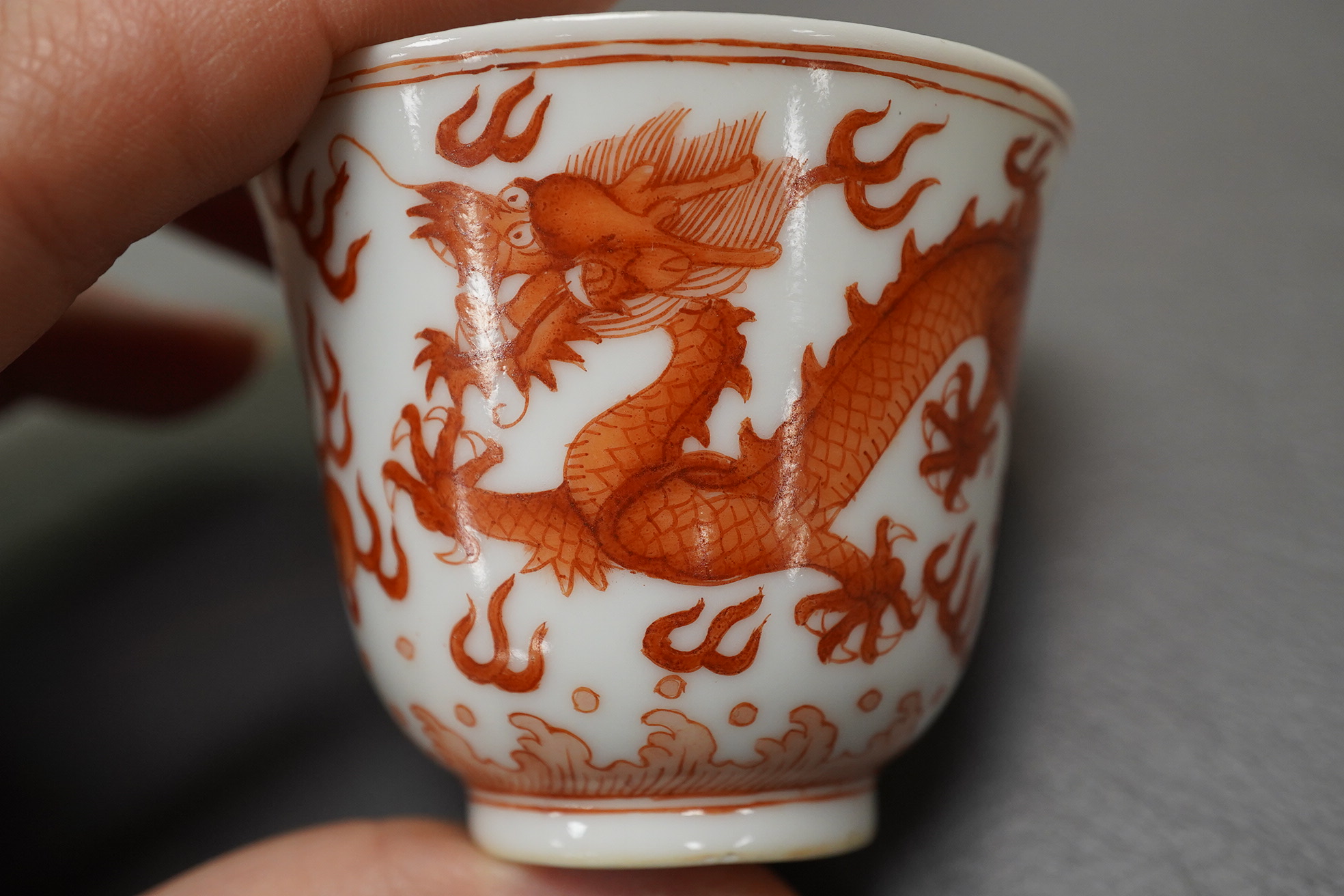 A pair of Chinese iron red ‘dragon’ cups, Guangxu six character mark and probably of the period (1875-1908)